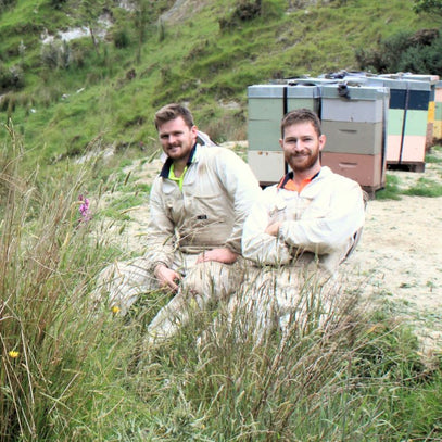 people in front of beehives